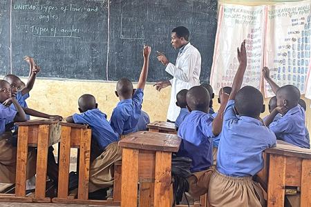 Teacher and students in a classroom in Rwanda