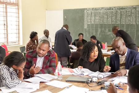 Large tables involved in group discussions at the STEP Malawi activity.