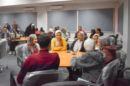 Groups sitting at tables during an activity for the USAID Teacher Excellence Initiative In Egypt
