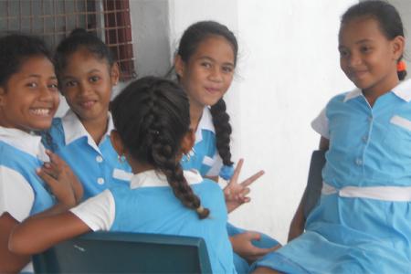 A small group of young school girls in uniform in Tuvalu