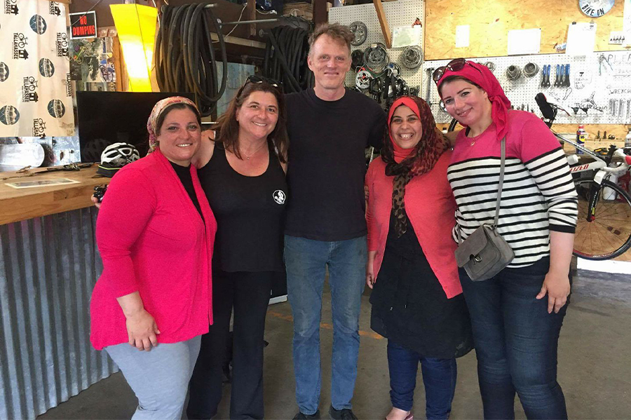 "Cyndi Harlow poses with a group of women from Egypt before a bike ride through the Cascades."