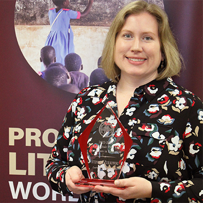 "Dr. Zuilkowski posing with the Ralph Stair Prize For Innovation In Education"