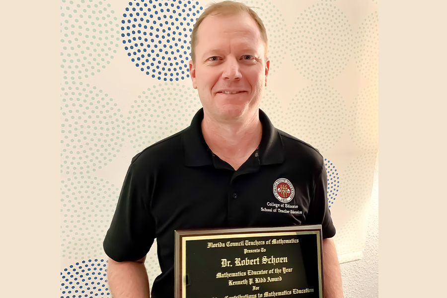 "Dr Schoen posing with the plaque for his Kidd Award"