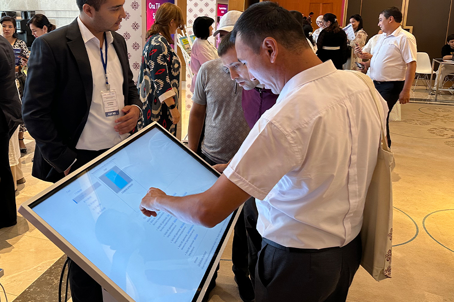 "Man touching a large interactive digital screen"