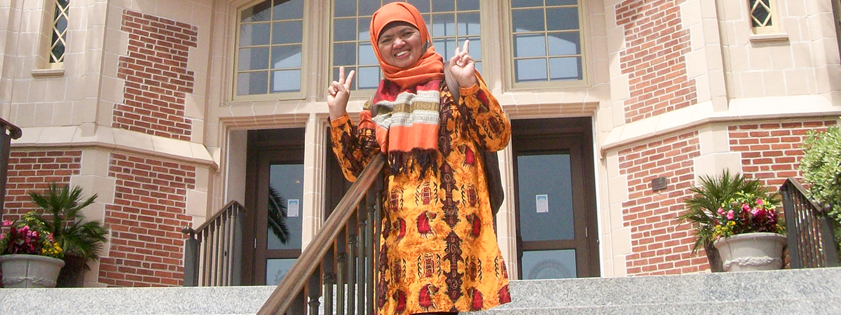 "Dr. Ely Djulia Katmadihardja takes a photo in front of the Westcott Building on the campus of FSU."