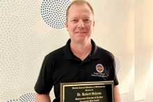 Dr. Robert Schoen poses with his  Kenneth P. Kidd Mathematics Educator of the Year plaque 