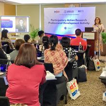 Dr. Marty in front of a room presenting in the Philippines