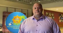Screenshot of a teacher being interviewed in front of a circular CPALMS banner.