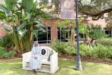 A member of the CCAP group sitting on a bench at the FSU Alumni Association