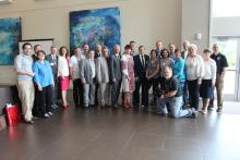 The CCAP Ukraine group posing for a photo in font of a painting at Santa Fe College