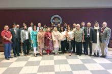CCAP Pakistan group photo indoors in front of the FSU seal
