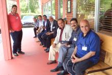 Group of members of the CCAP Egypt delegation sitting on a bench