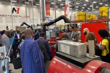 Members of the CCAP South Africa group inside a machine shop at Valencia College listening to a speaker