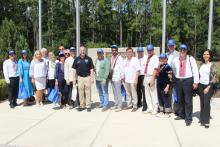 Group photo in blue baseball hats outside of Santa Fe College 