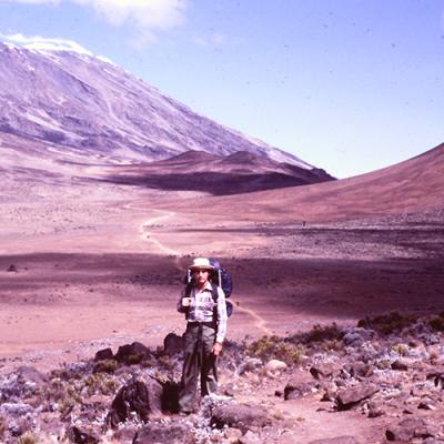 Dr. Jeffrey Milligan in Tanzania standing in front of Mount Kilimanjaro.
