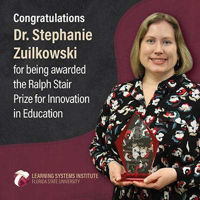 Graphic featuring Dr. Zuilkowski posing with a trophy. The text reads 'Congratulations Dr. Stephanie Zuilkowski for being awarded the Ralph Stair Prize for Innovation in Education'.