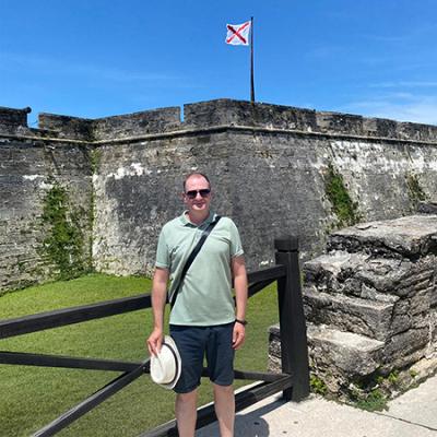 Dr. Andrii Roskladka posing in front of the old settlements in St. Augustine, Florida.